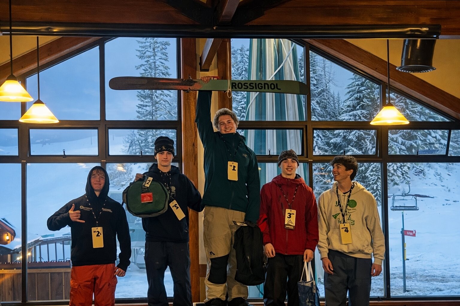 Darien wins Crystal Mountain 2026, holding ski overhead on the podium