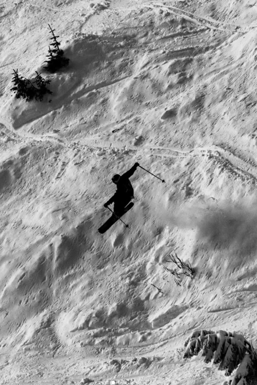 Skiing a backcountry line, black and white